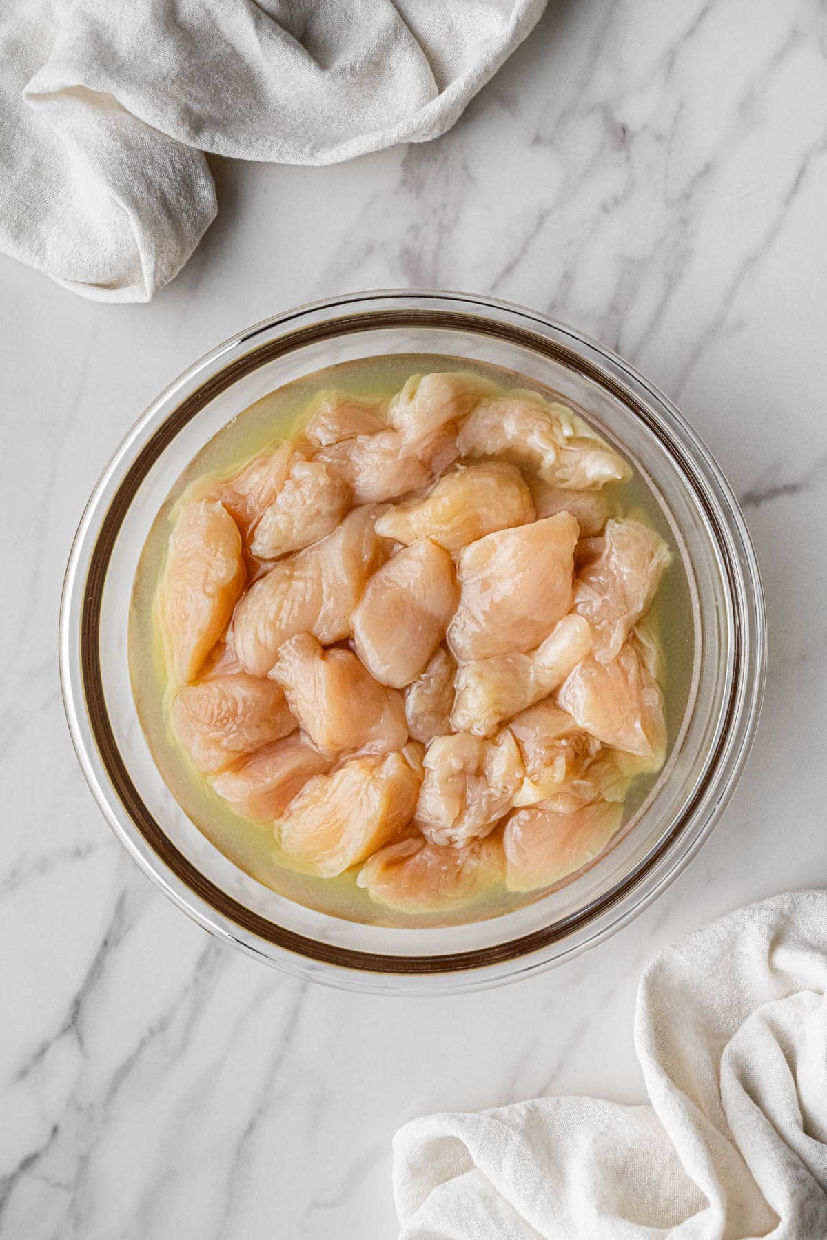 meat pieces in pickle juice in clear bowl