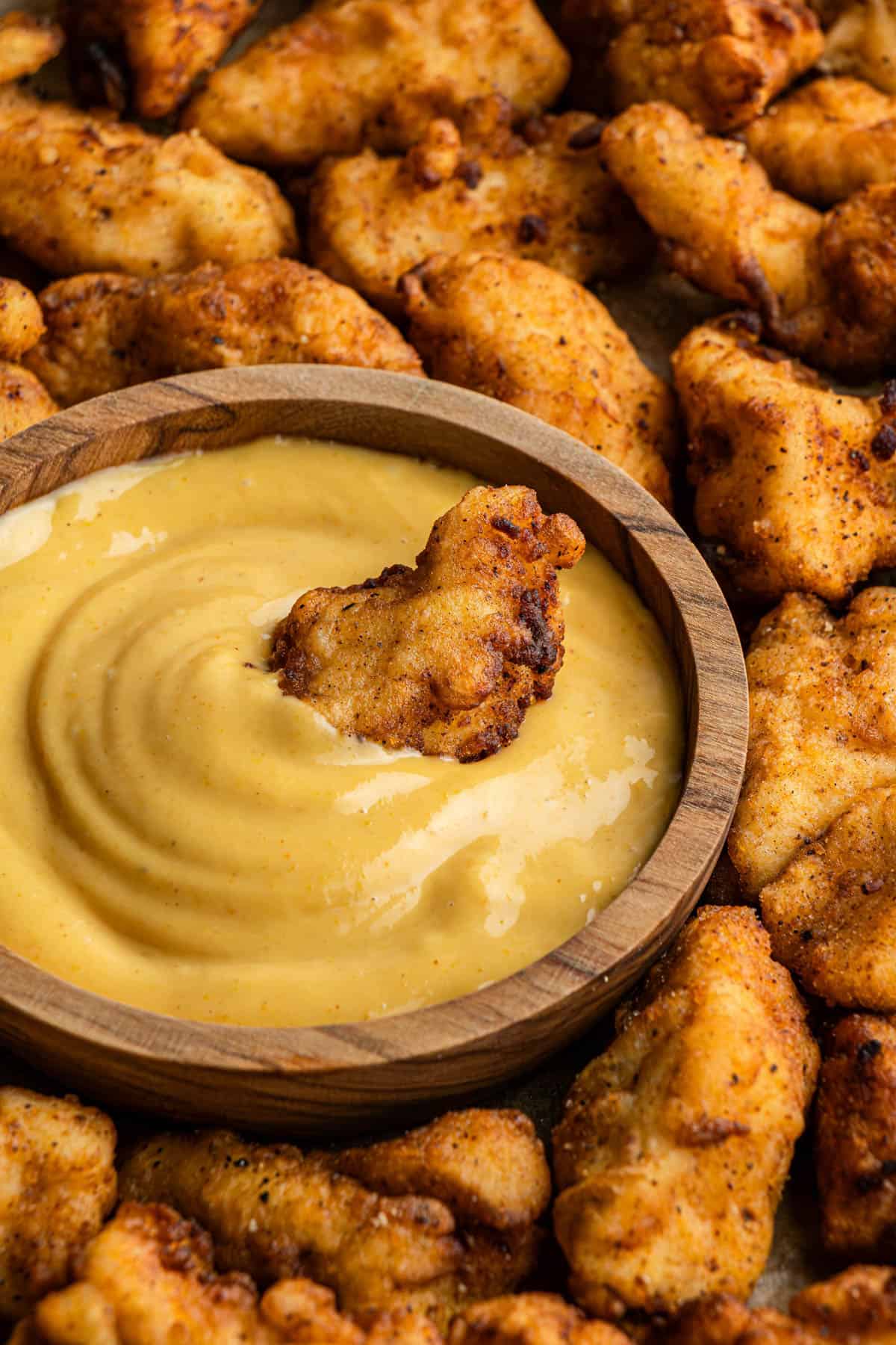 chick-fil-a sauce copycat recipe in wooden bowl with chicken nugget in it