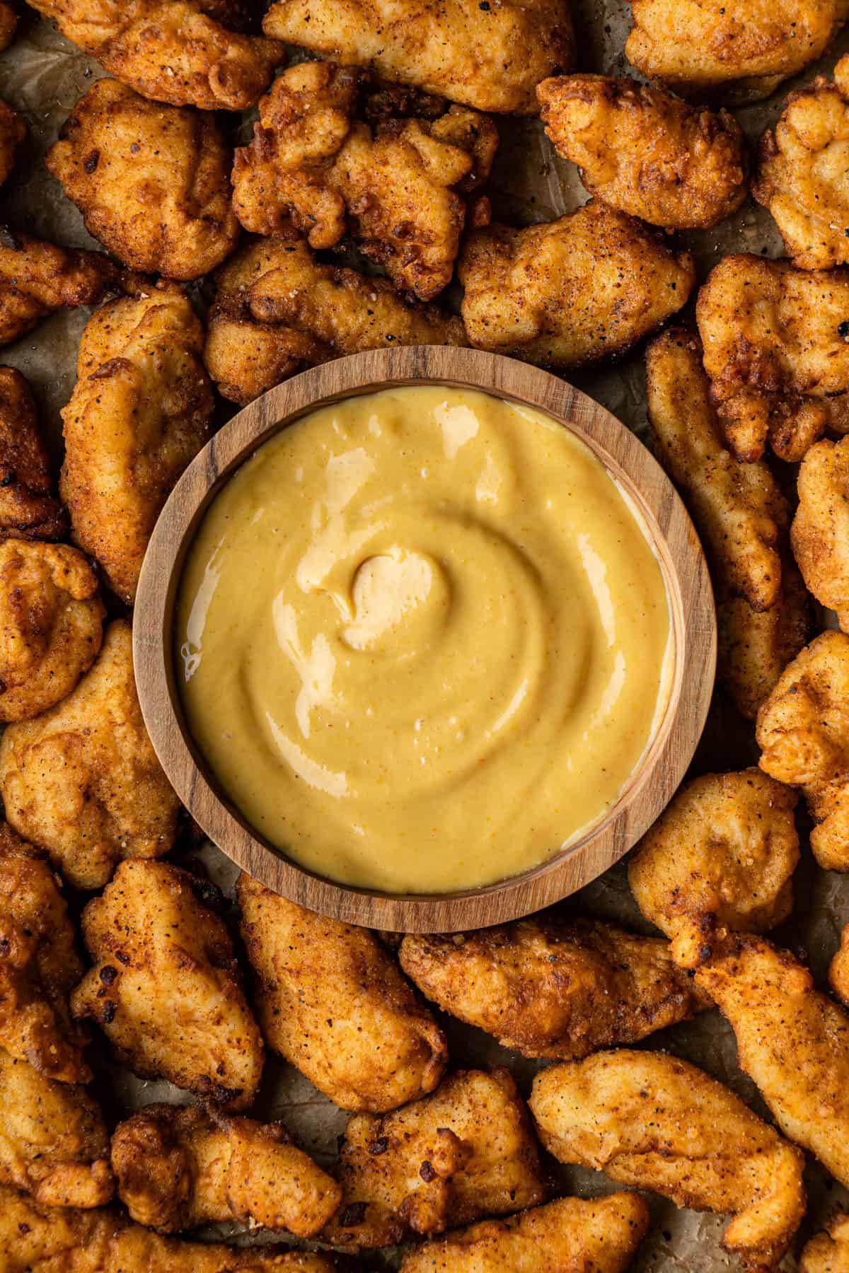 chick-fil-a sauce copycat recipe in wooden bowl with chicken nugget in it