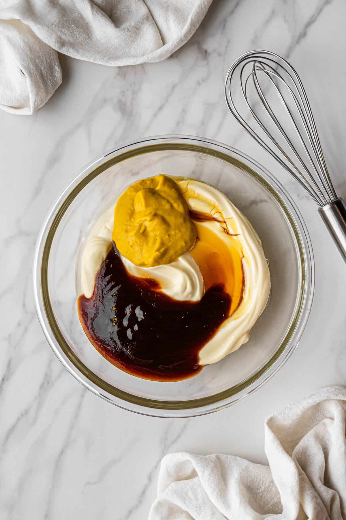 ingredients in clear bowl with whisk