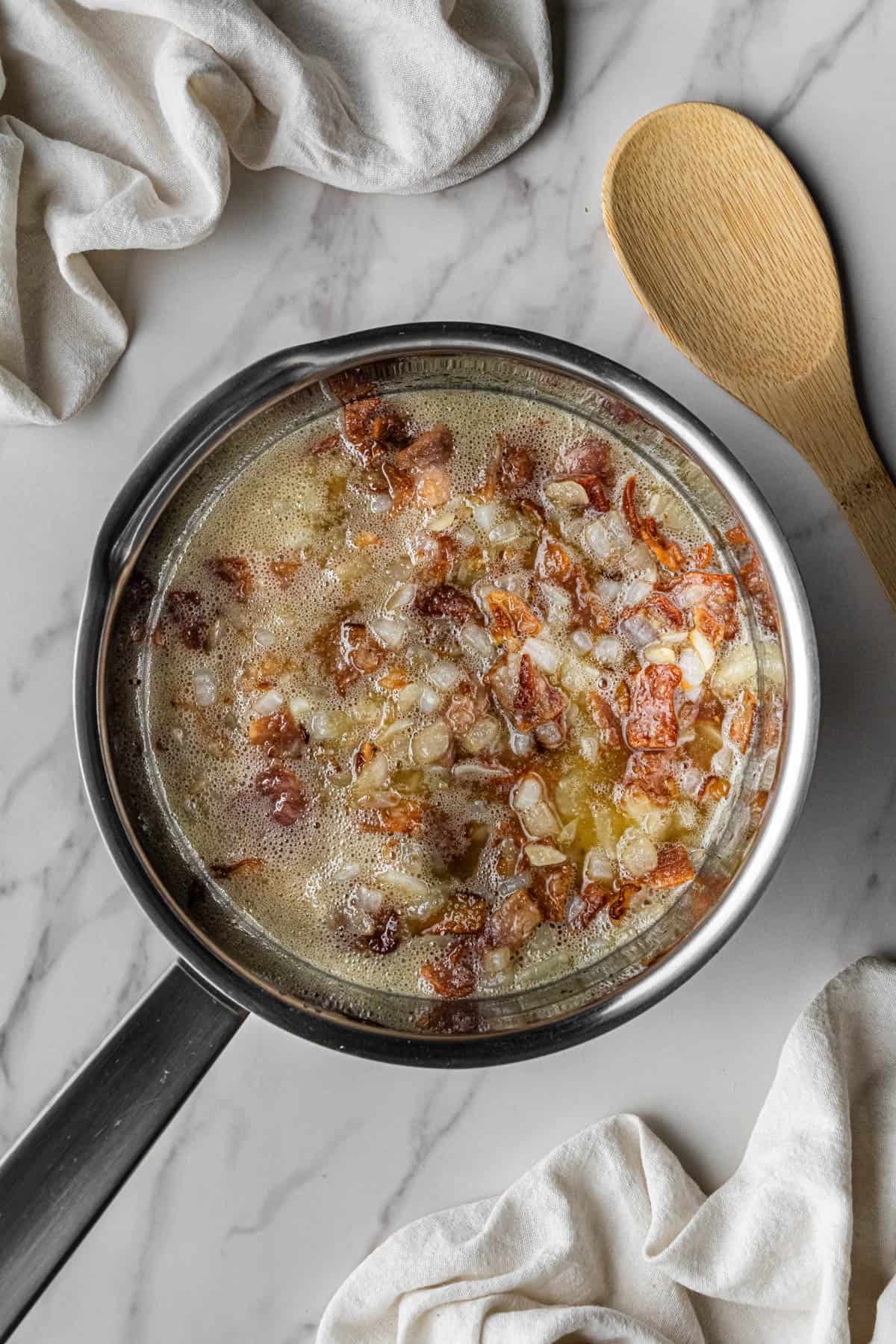 bacon and onions cooking in pan
