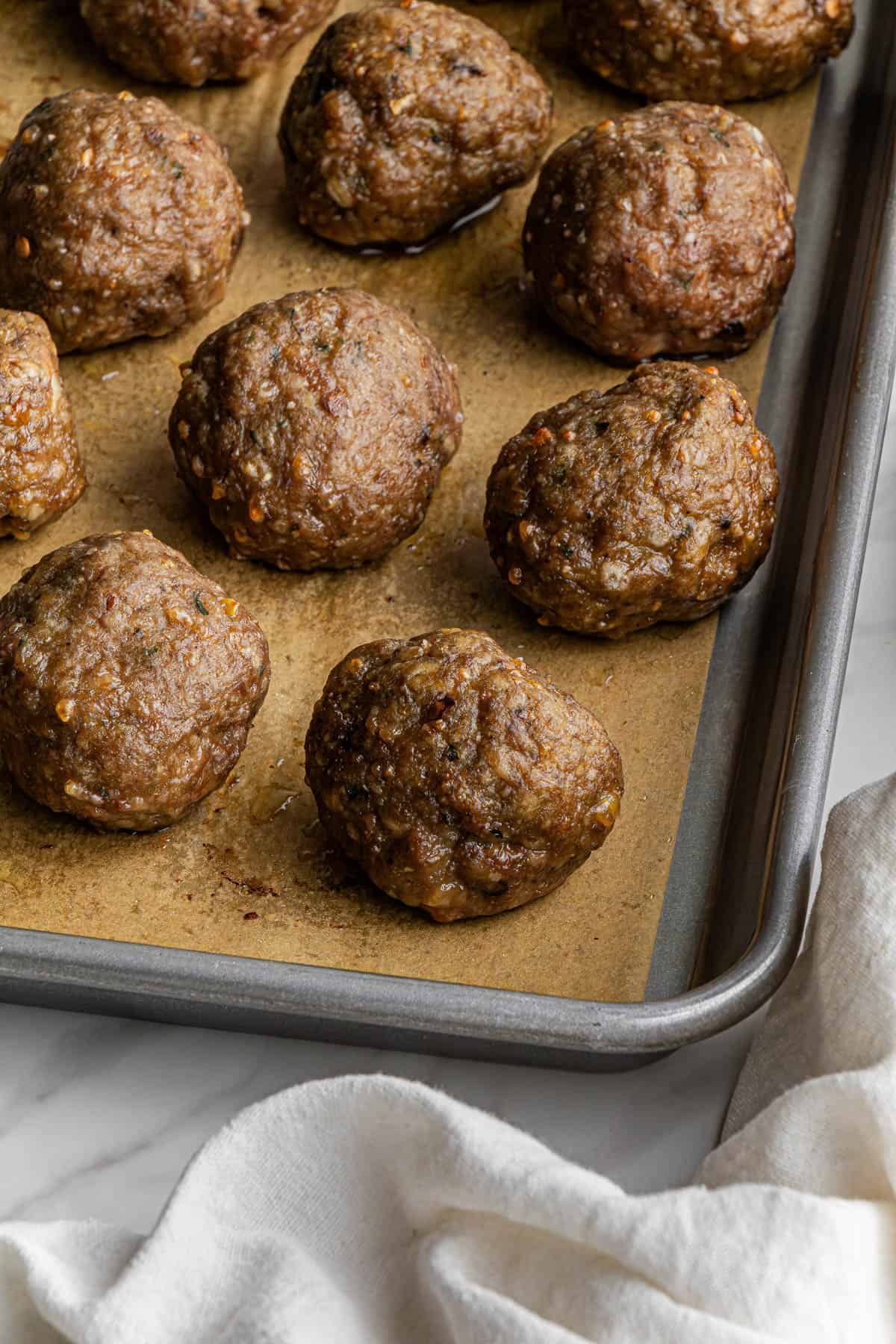 olive garden meatballs recipe on a baking sheet lined with parchment paper