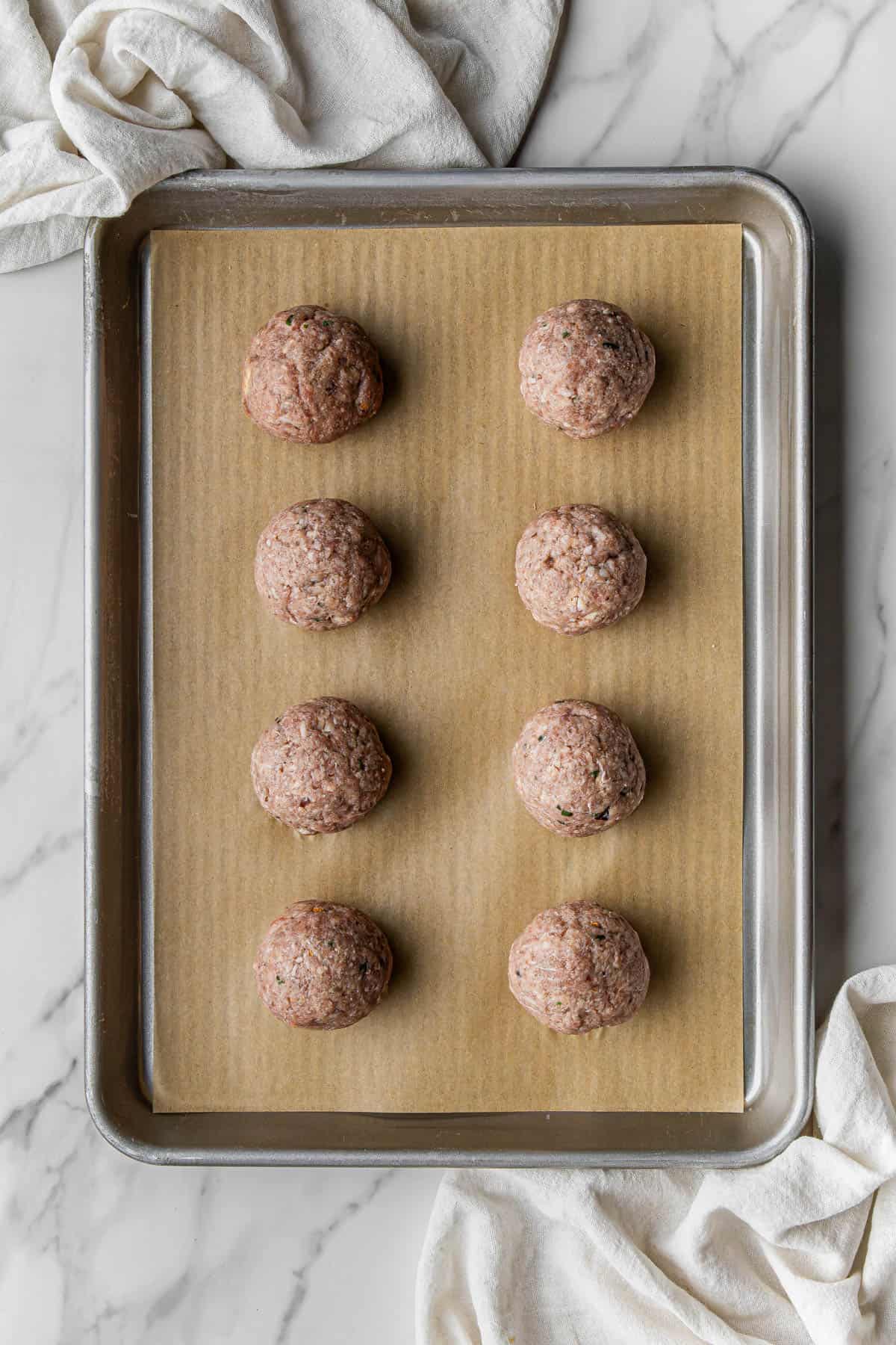 uncooked ingredients on a baking sheet lined with parchment paper