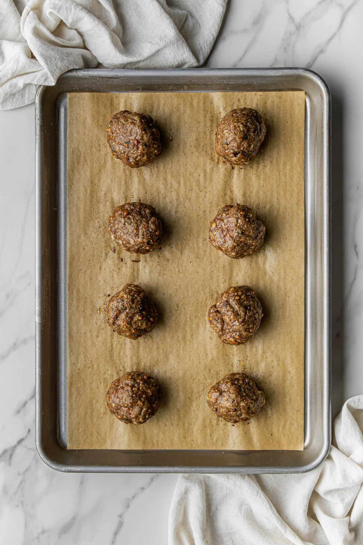 cooked ingredients on a baking sheet lined with parchment paper on a baking sheet lined with parchment paper