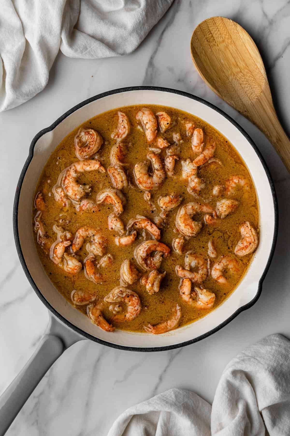 white wine and red pepper flakes in skillet with meat