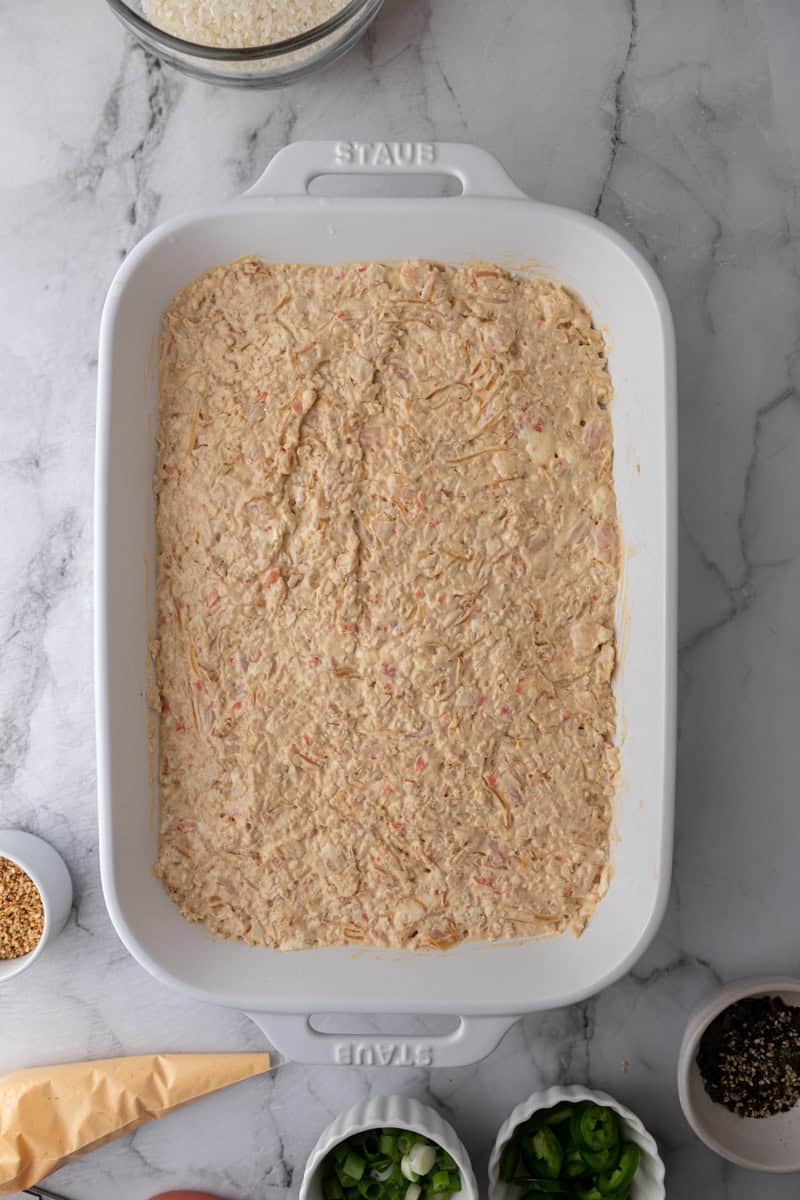 rice and seafood layered in a baking dish