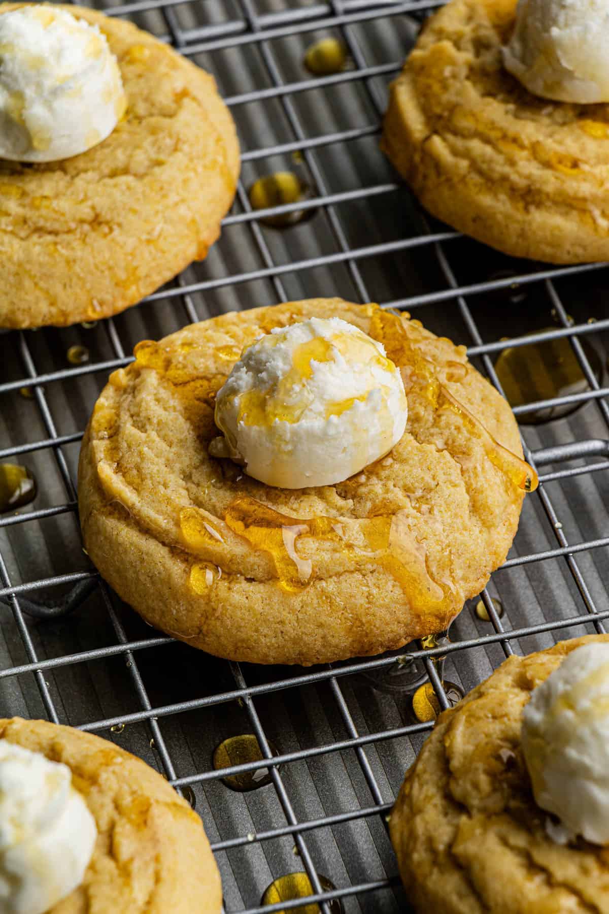 5 Crumbl Copycat Cornbread Cookies topped with Honey Buttercream placed on top of a wire rack.