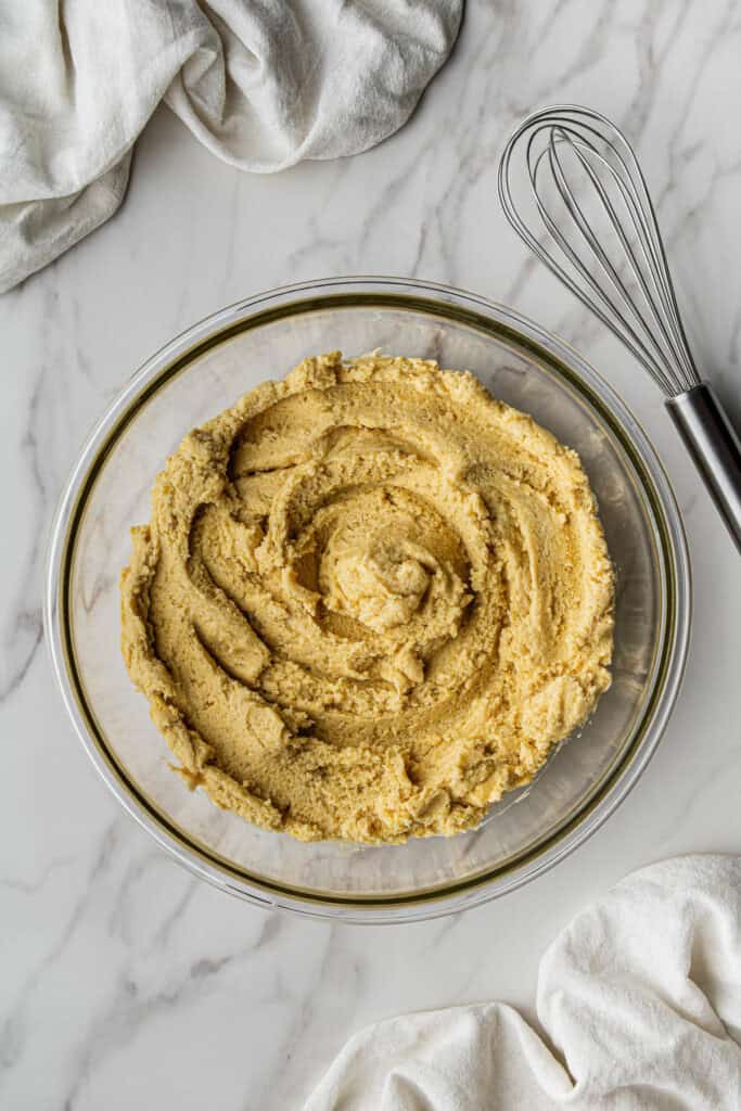Flat lay shot of a glass bowl with batter in it.