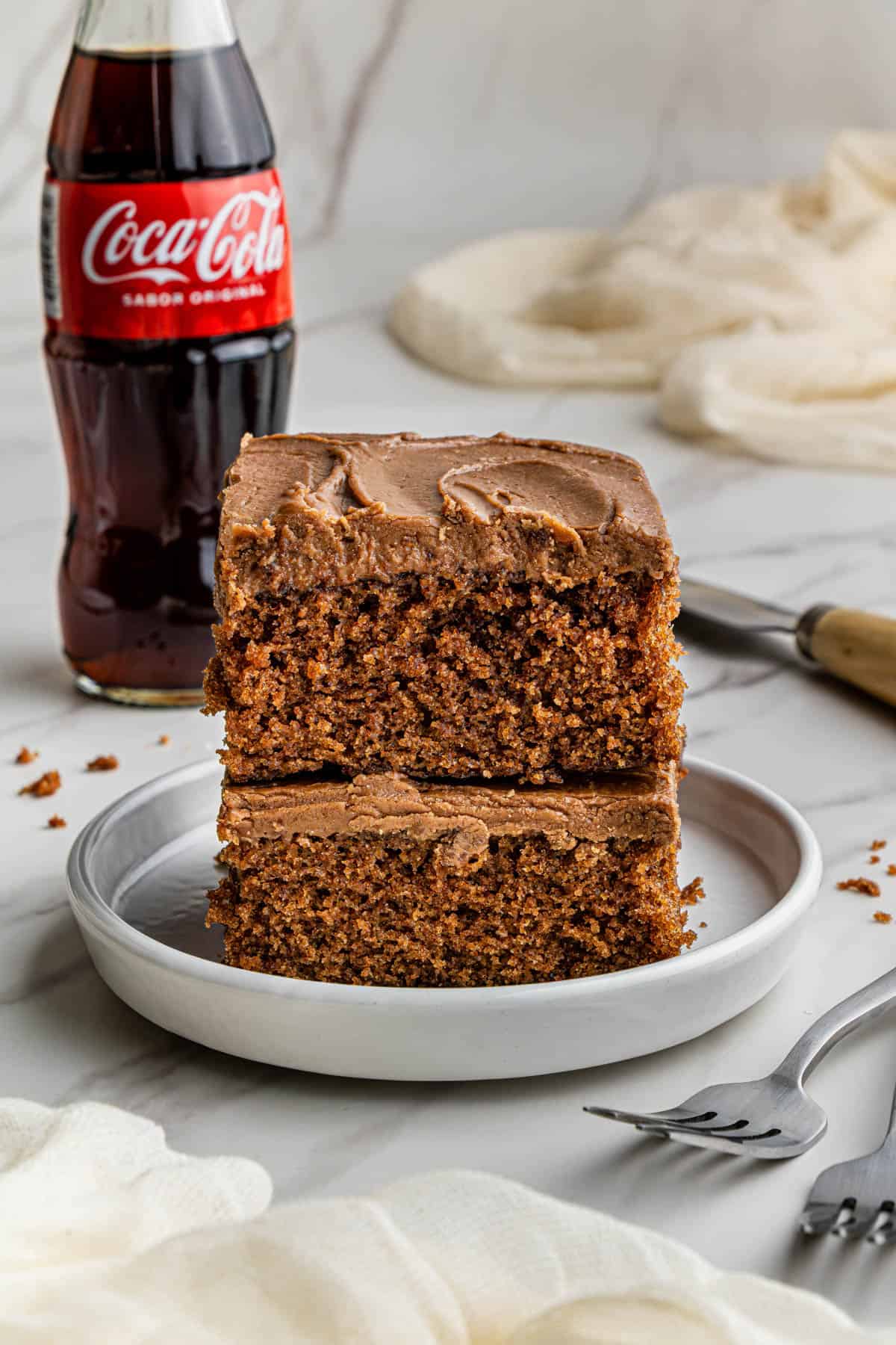 Two slices of Cracker Barrel Coca cola Cake recipe stacked on top of each other.