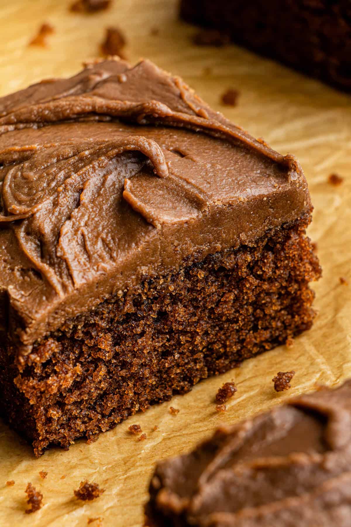 A closeup shot of a slice of the Cracker Barrell Coca-Cola Cake recipe on a sheet pan.