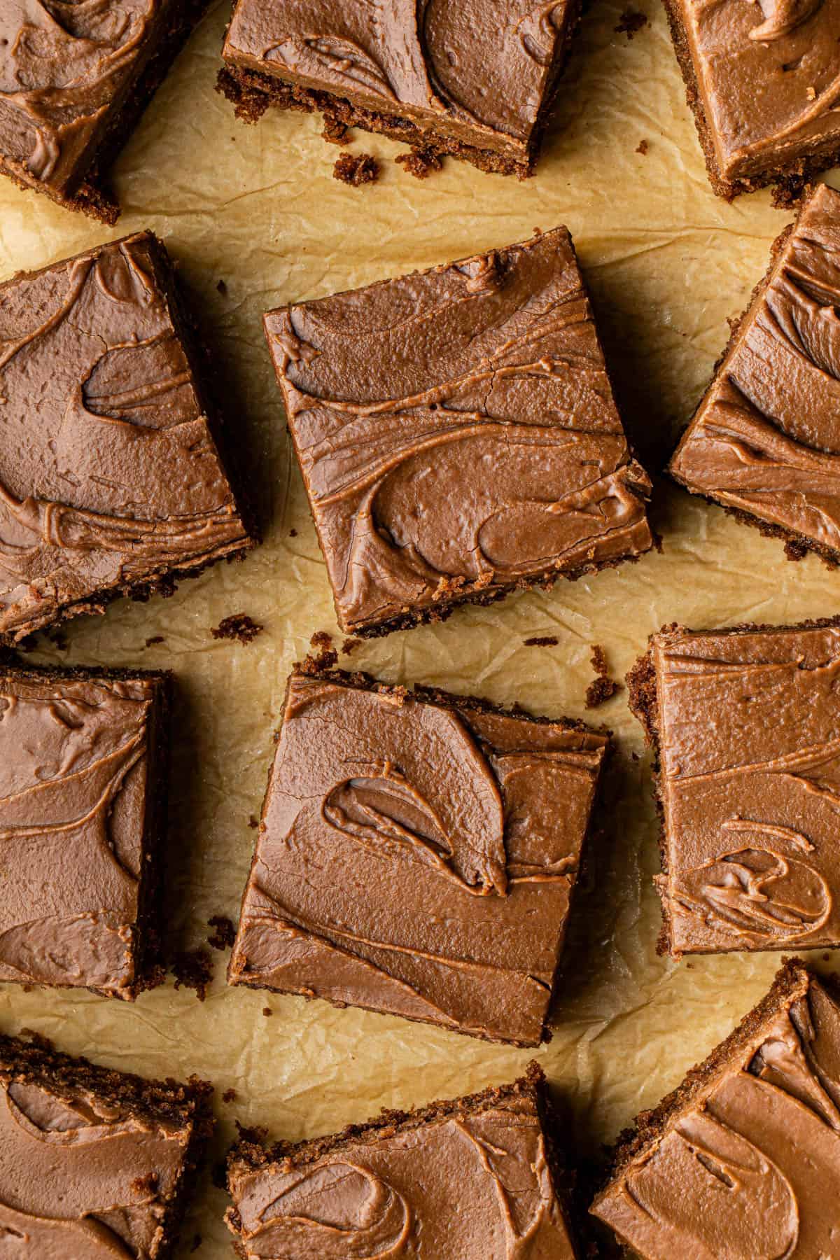 Flat lay shot of a batch of square cracker barrel Coca-Cola cake recipe slices on a sheet tray.