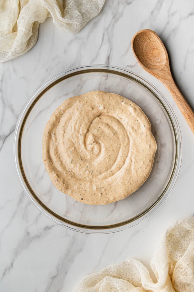 Flat lay shot of a glass bowl with dip in it.