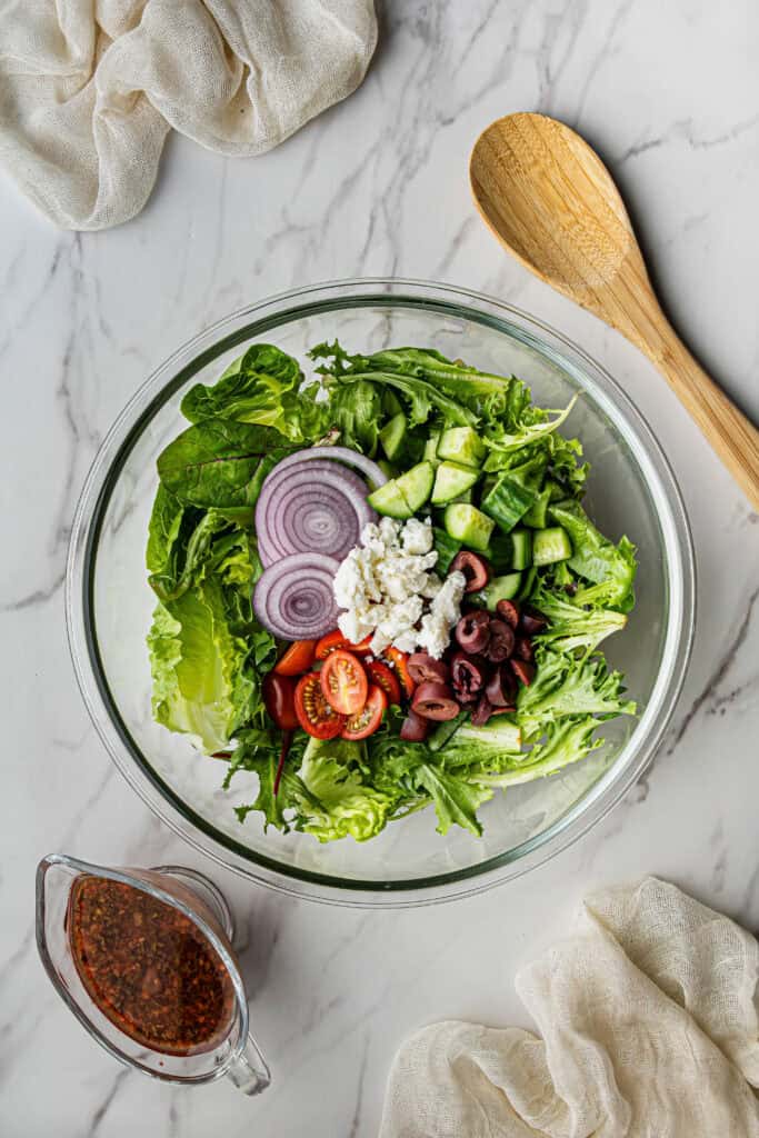 unmixed salad ingredients in a bowl