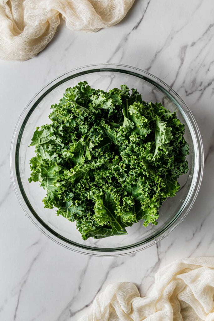 A glass bowl with crunchy greens in it.