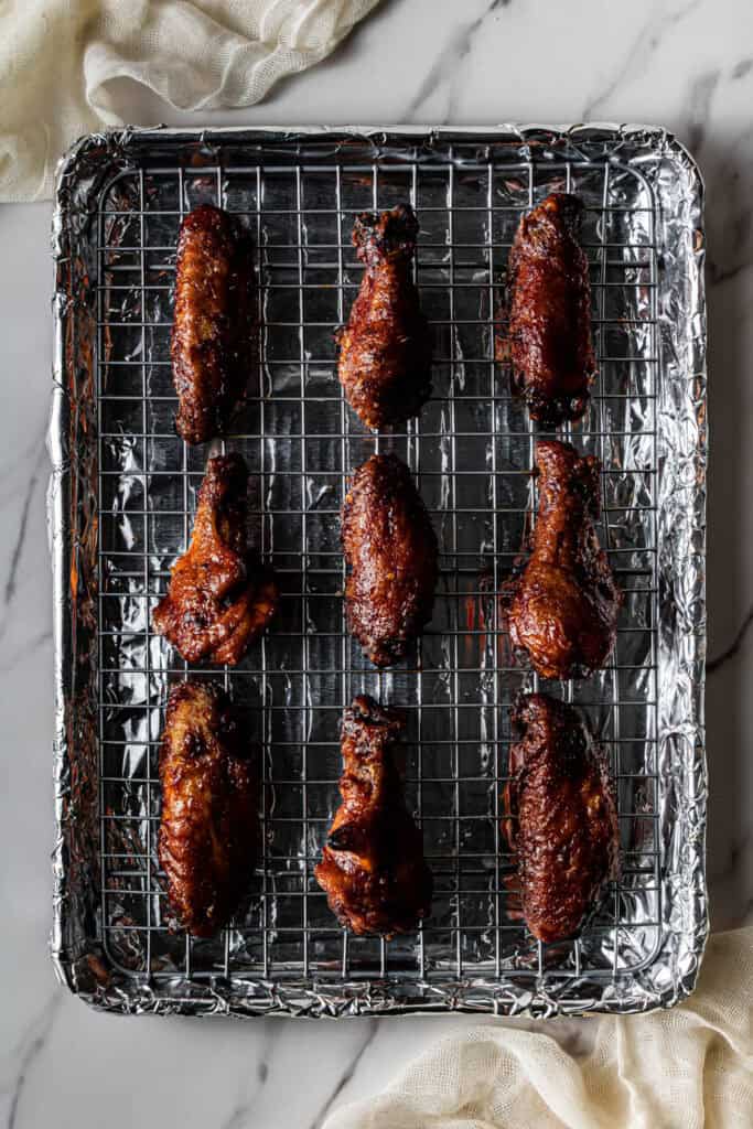 meat on a wire rack on a baking sheet