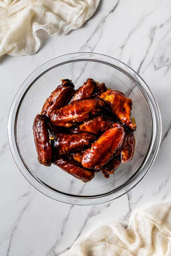 meat tossed in sauce in a bowl