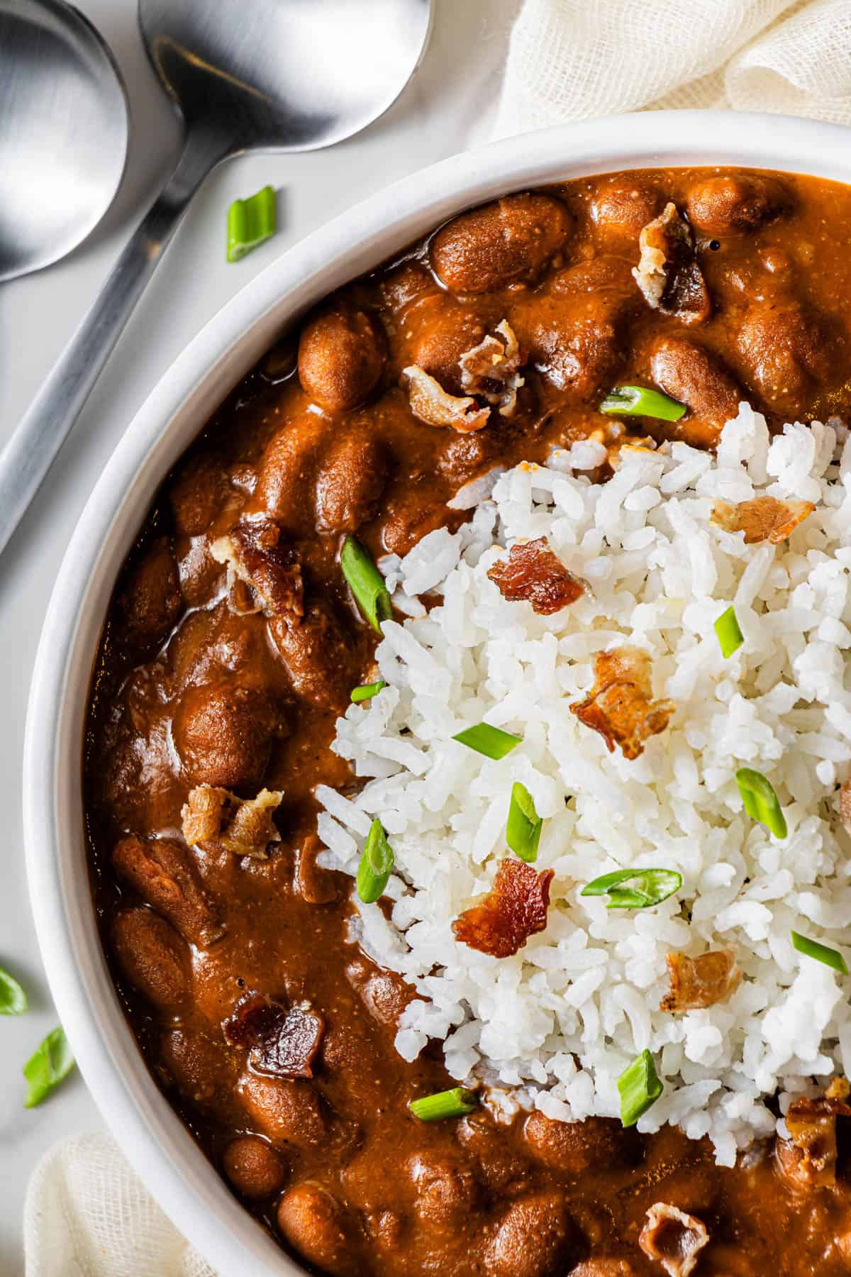 Partial flat lay shot of a shallow bowl with Popeye's Copycat Red Beans and Rice.