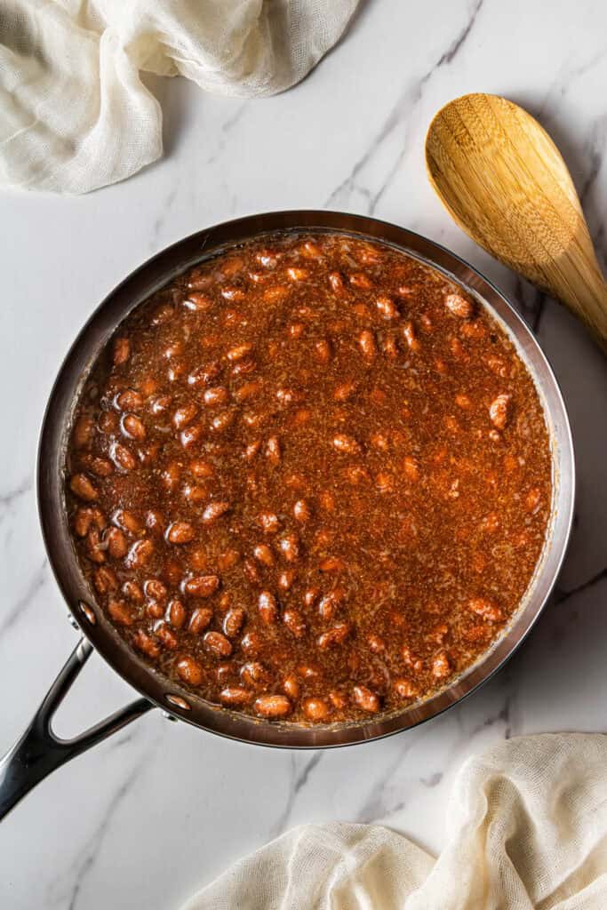 A skillet with red beans simmering in it.