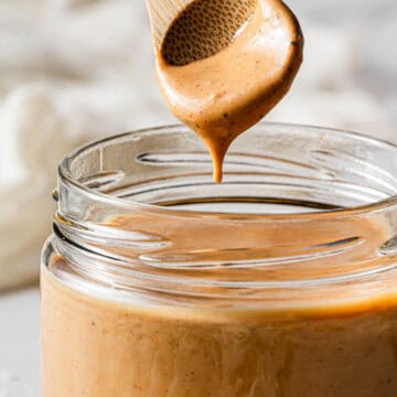 A glass jar with Copycat Raising Cane sauce in it.