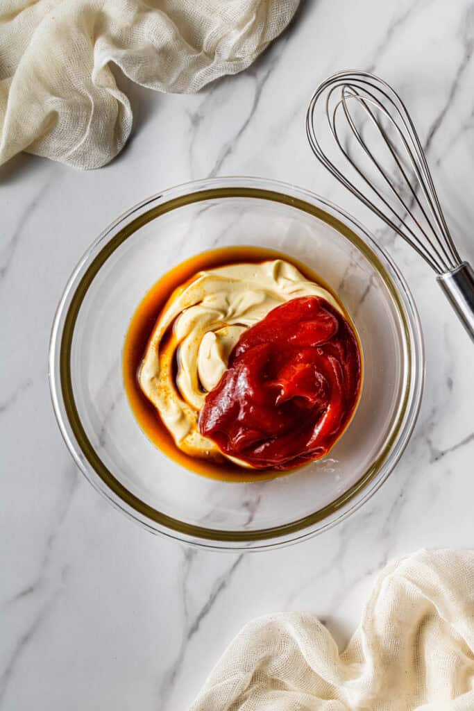 Bowl with mayonnaise, ketchup, Worcestershire sauce, and seasonings ready to be whisked into a dipping sauce.