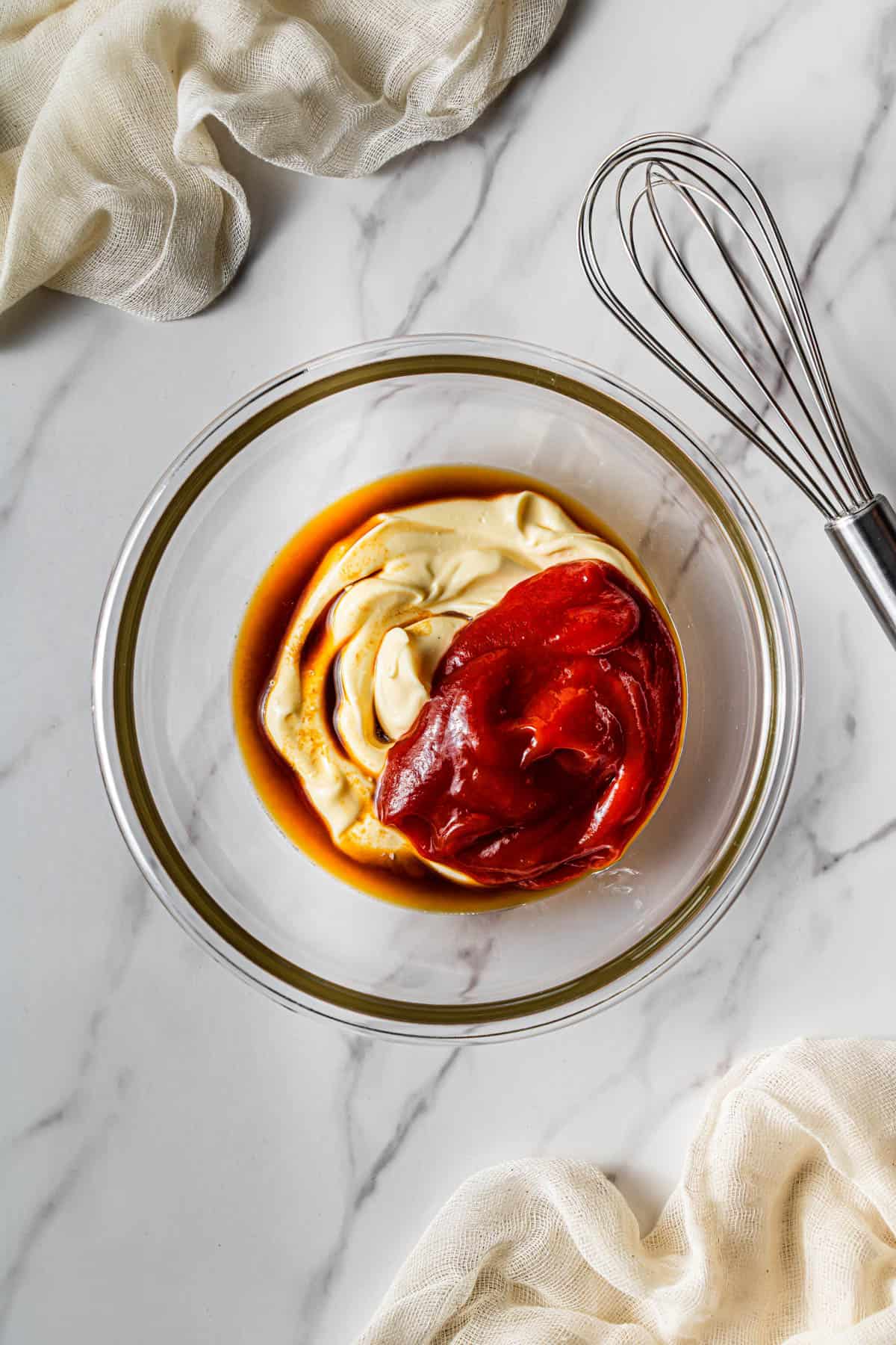 Bowl with mayonnaise, ketchup, Worcestershire sauce, and seasonings ready to be whisked into a dipping sauce.