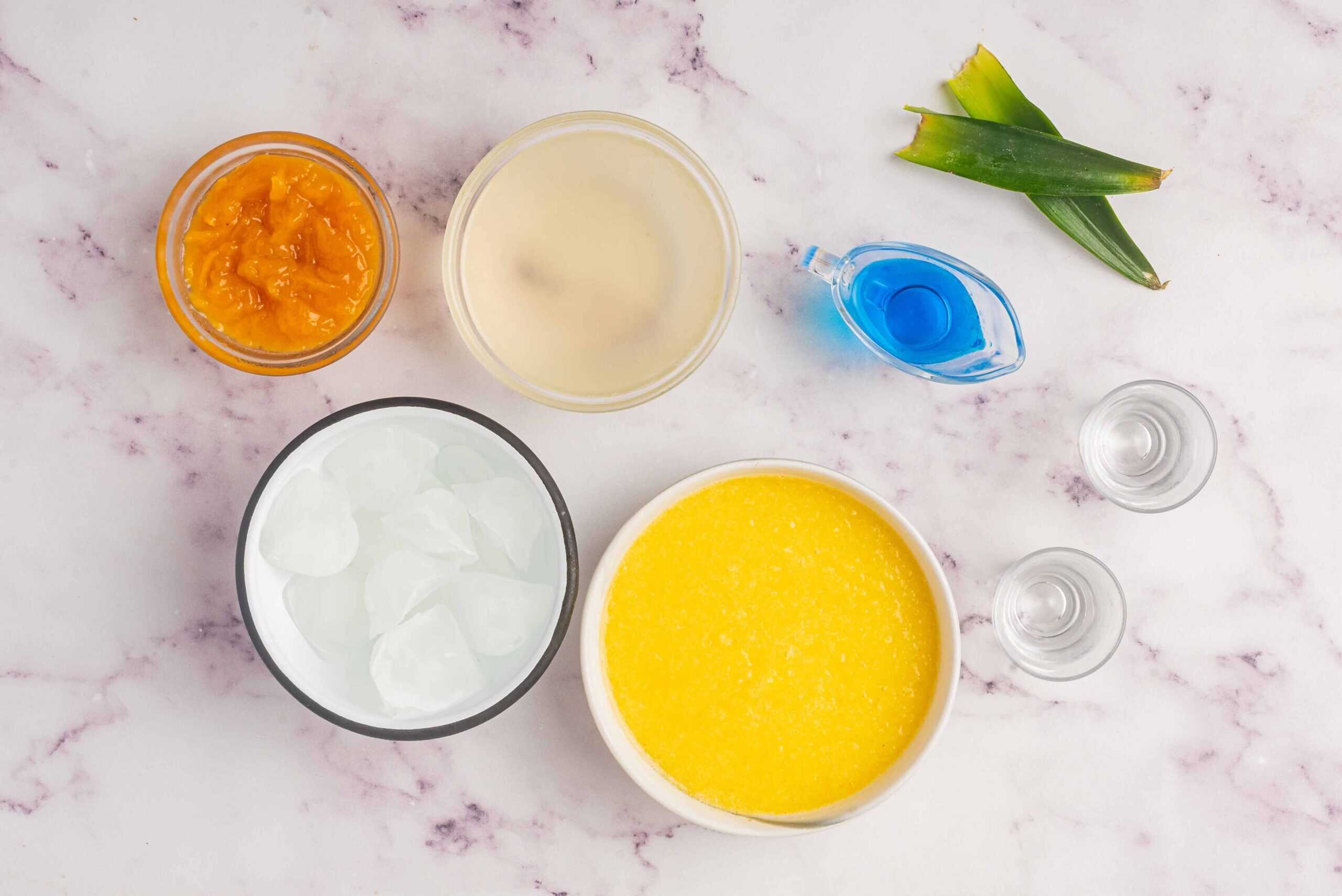 Ingredients for Cheddar’s Island Tiki Cocktail including mango puree, pineapple juice, blue curaçao, and ice