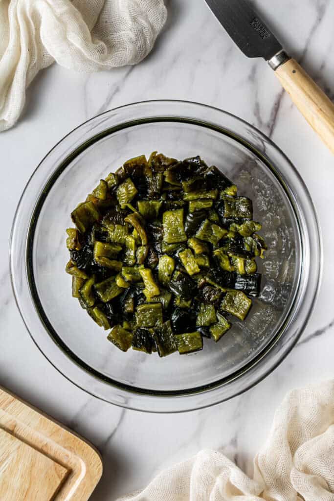 Chopped roasted poblano pepper in a glass bowl