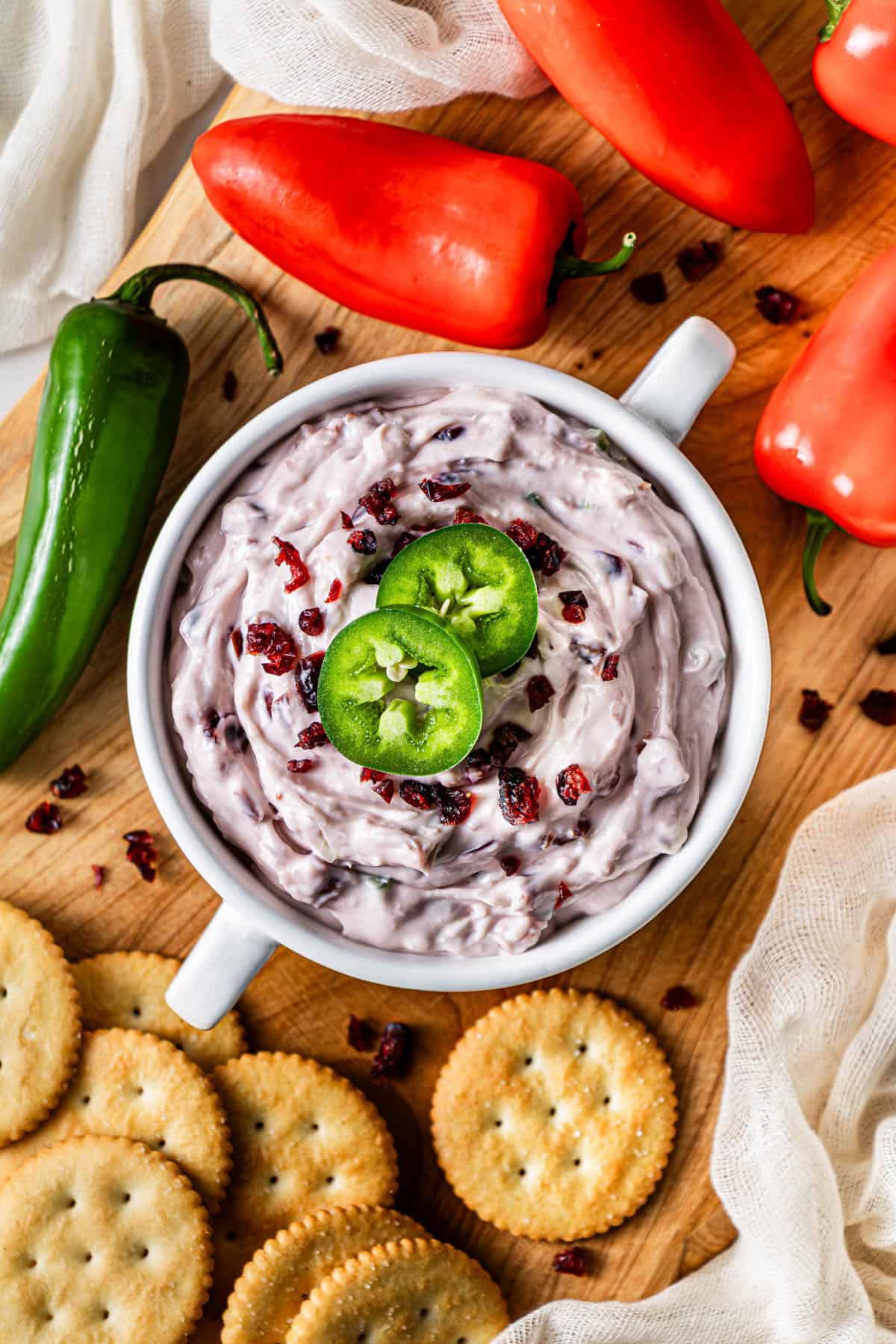 overhead shot of creamy cranberry jalapeño cream cheese dip with crackers