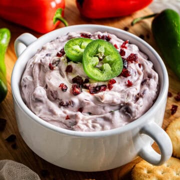 copycat La Terra Fina cranberry jalapeño dip in a white bowl served with crackers