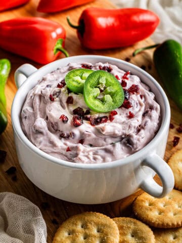 copycat La Terra Fina cranberry jalapeño dip in a white bowl served with crackers