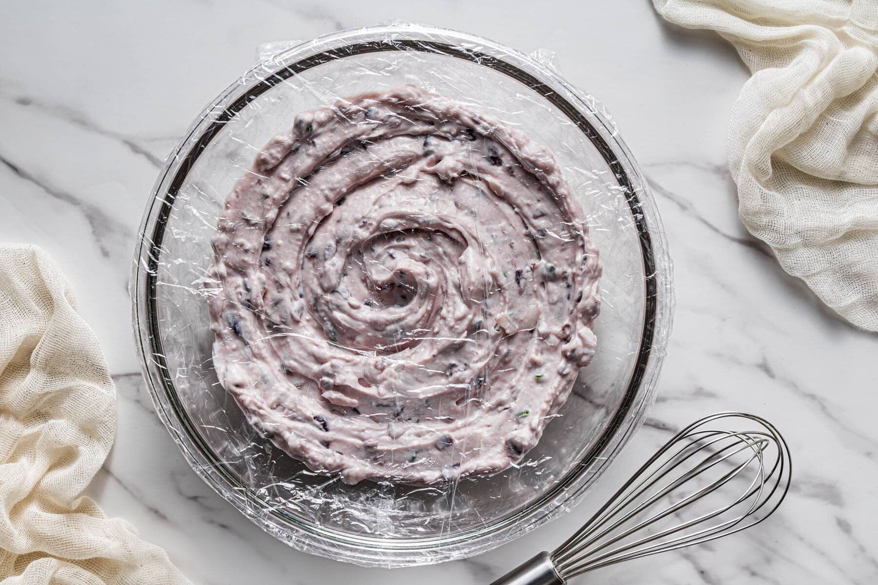 cranberry jalapeño dip covered and chilling in bowl before serving