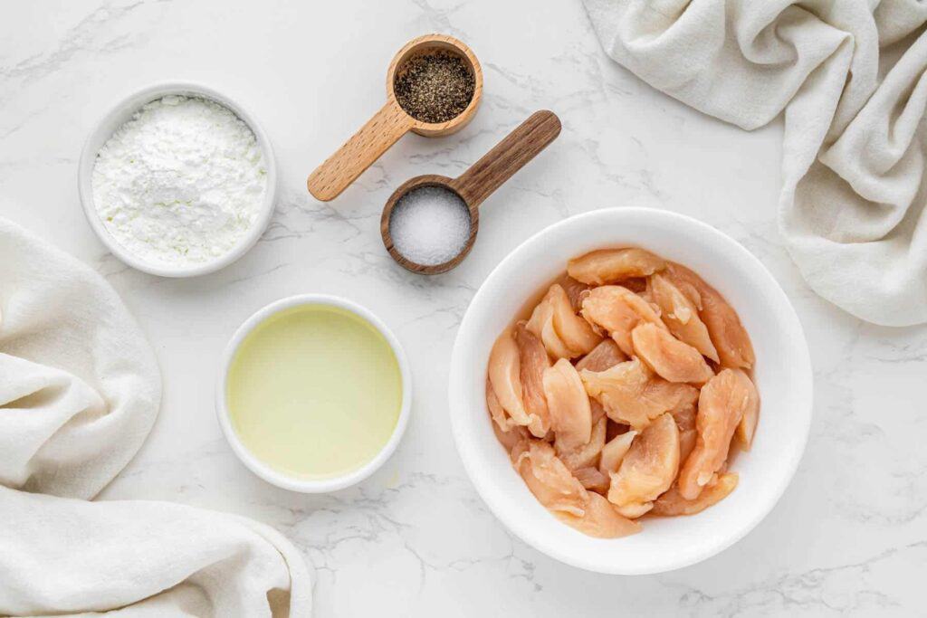 Sliced chicken breast, oil, cornstarch, salt and pepper for bourbon chicken