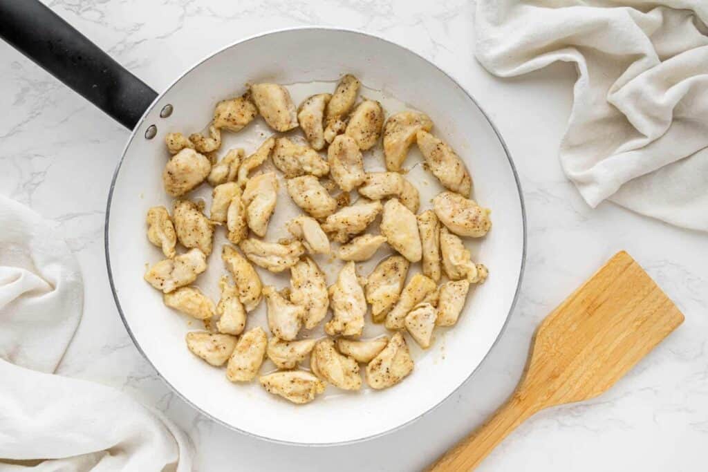 Chicken cooking in skillet for bourbon chicken recipe
