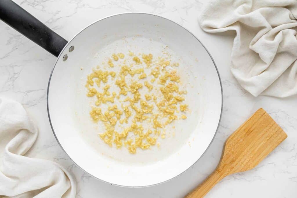 Minced garlic sautéing in skillet