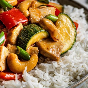Panda Express kung pao chicken copycat served over white rice in a ceramic bowl