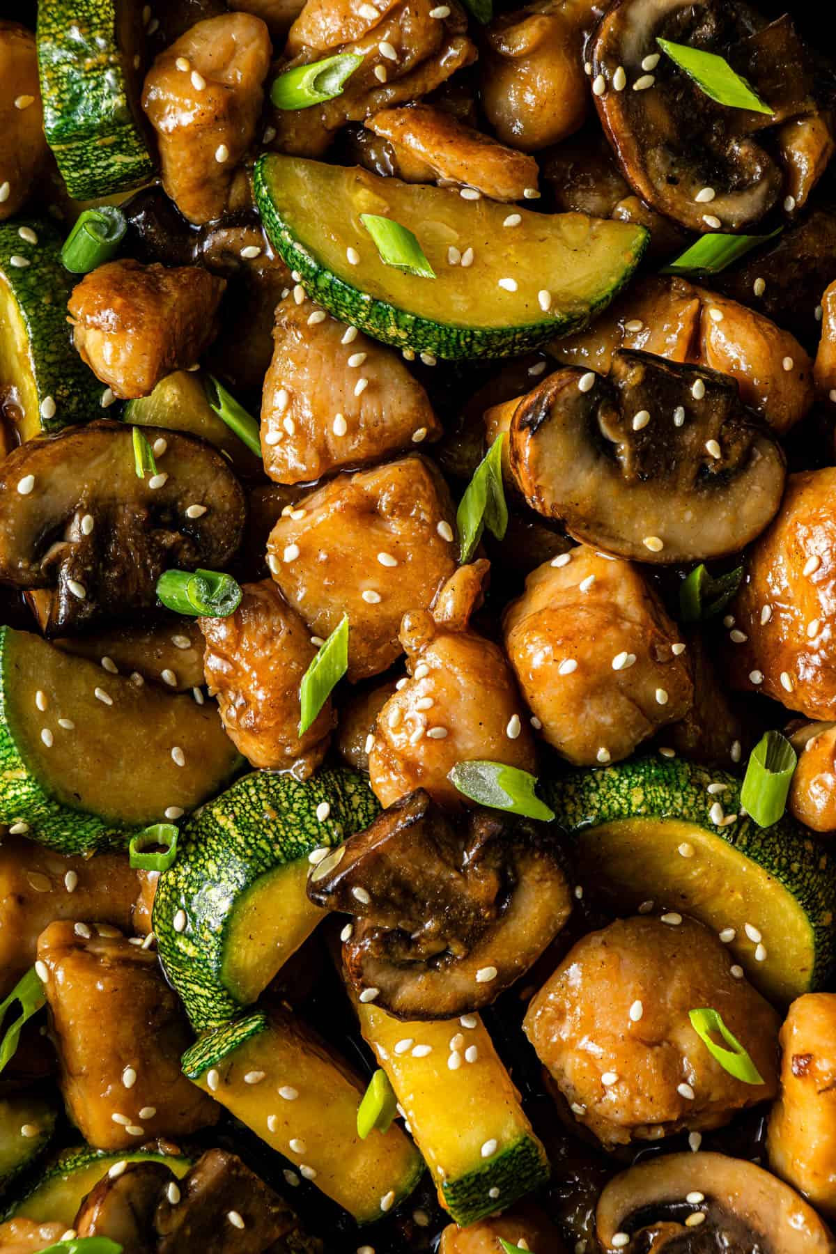 Close-up of mushroom chicken with zucchini and sesame seeds