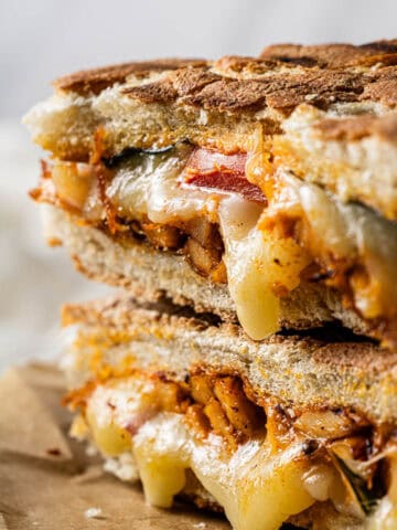 Copycat Panera Frontega Chicken Sandwich stacked with seasoned chicken, melted mozzarella, tomatoes, and toasted focaccia