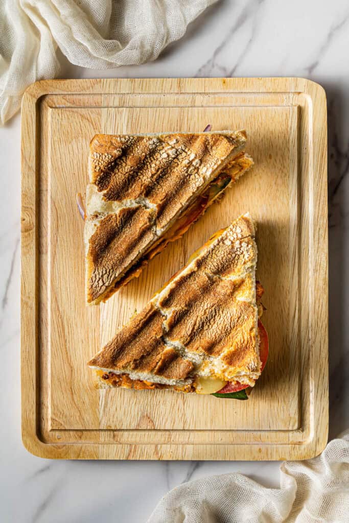 Grilled chicken panini cut into triangles with crispy grill marks