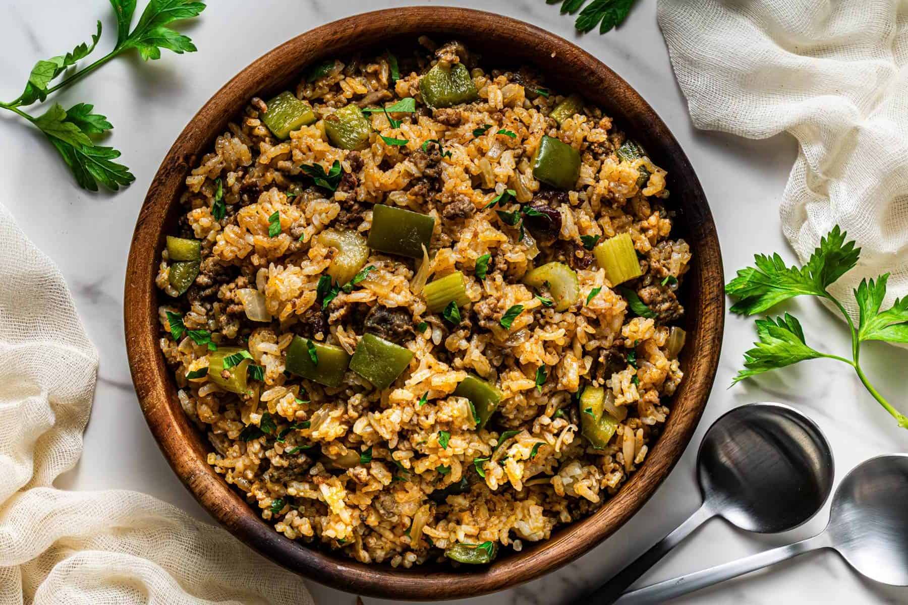 Homemade Popeye’s Cajun Rice served in a wooden bowl with parsley garnish