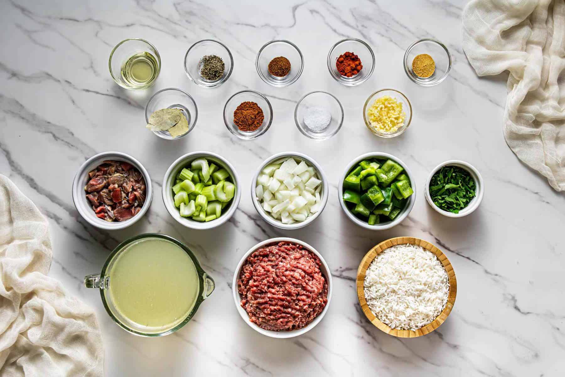 Ingredients needed to make Popeye’s Cajun Rice including ground beef, chicken gizzards, bell pepper, celery, and Cajun spices