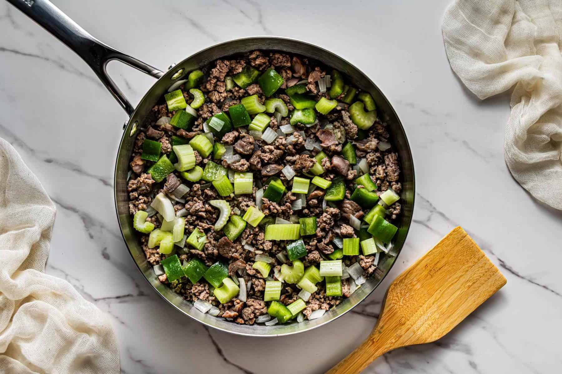 Onion, celery, and green bell pepper added to skillet for Popeye’s Cajun Rice copycat