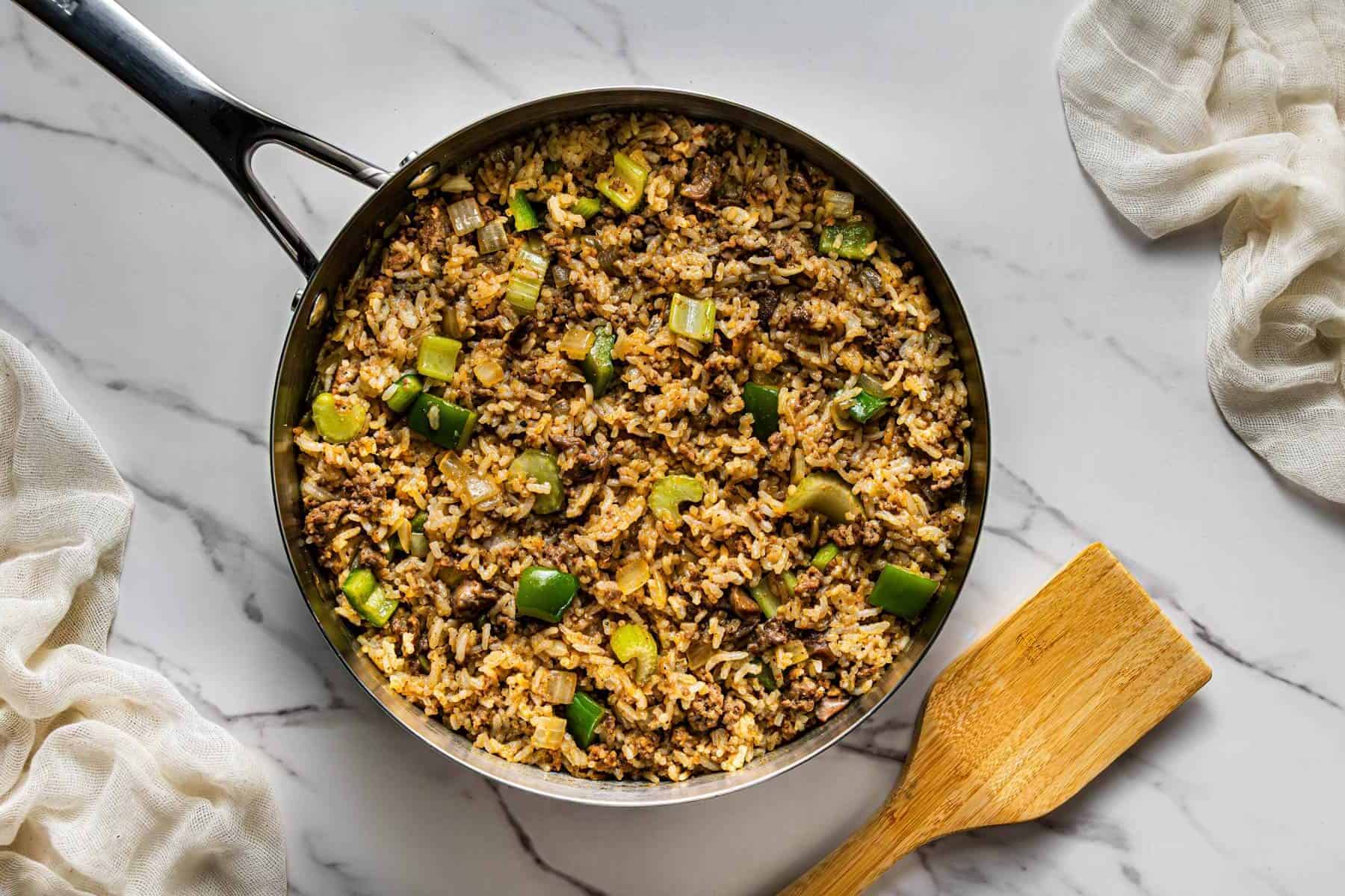 Copycat Popeye’s Cajun Rice mixed with beef, gizzards, and Cajun spices in skillet