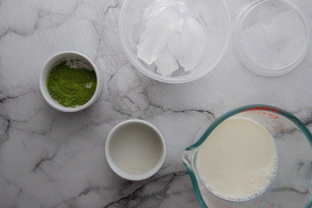 Ingredients for Starbucks matcha latte including matcha powder and milk