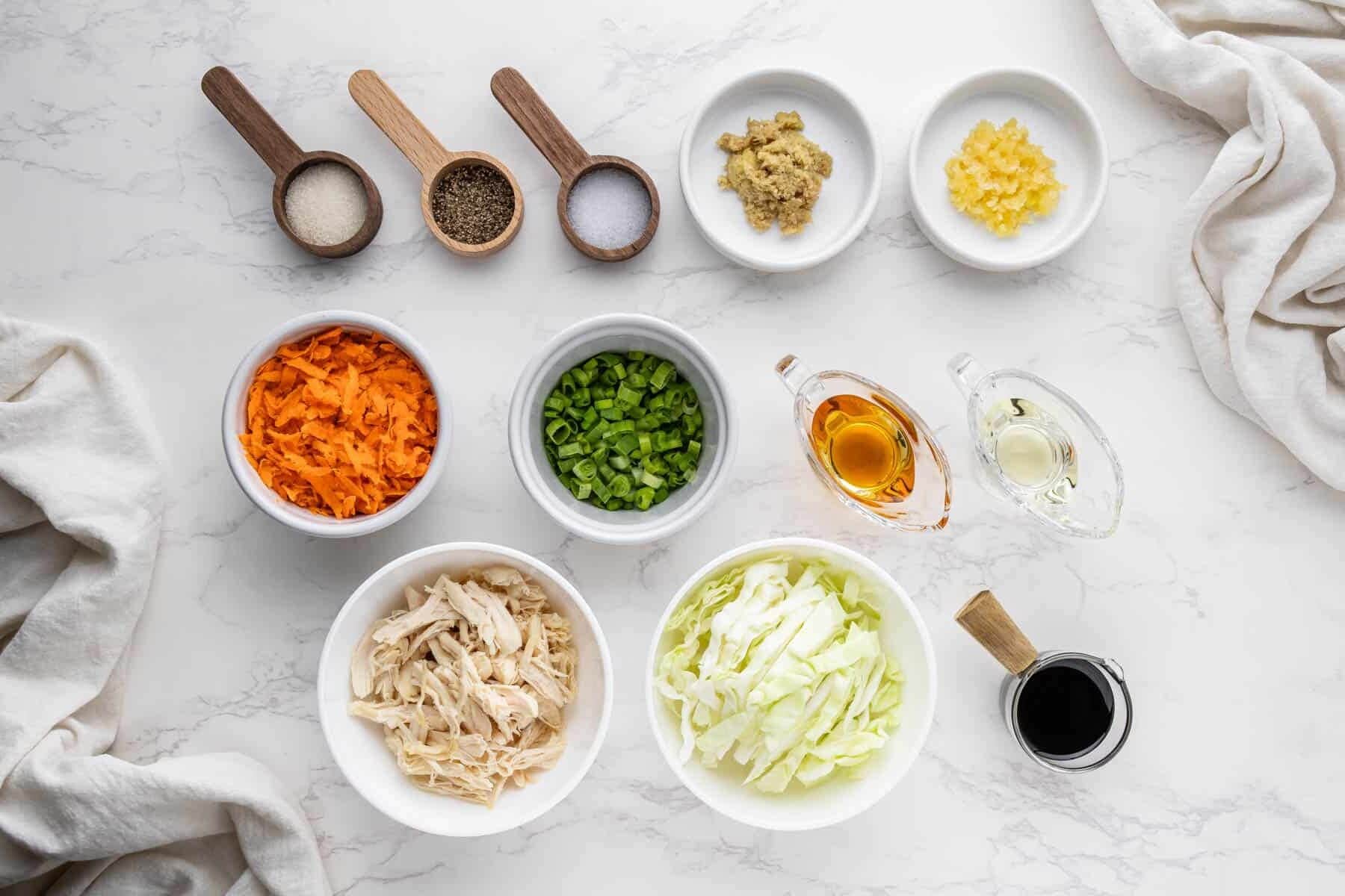 overhead view of panda express chicken egg roll filling ingredients in separate bowls and spoons