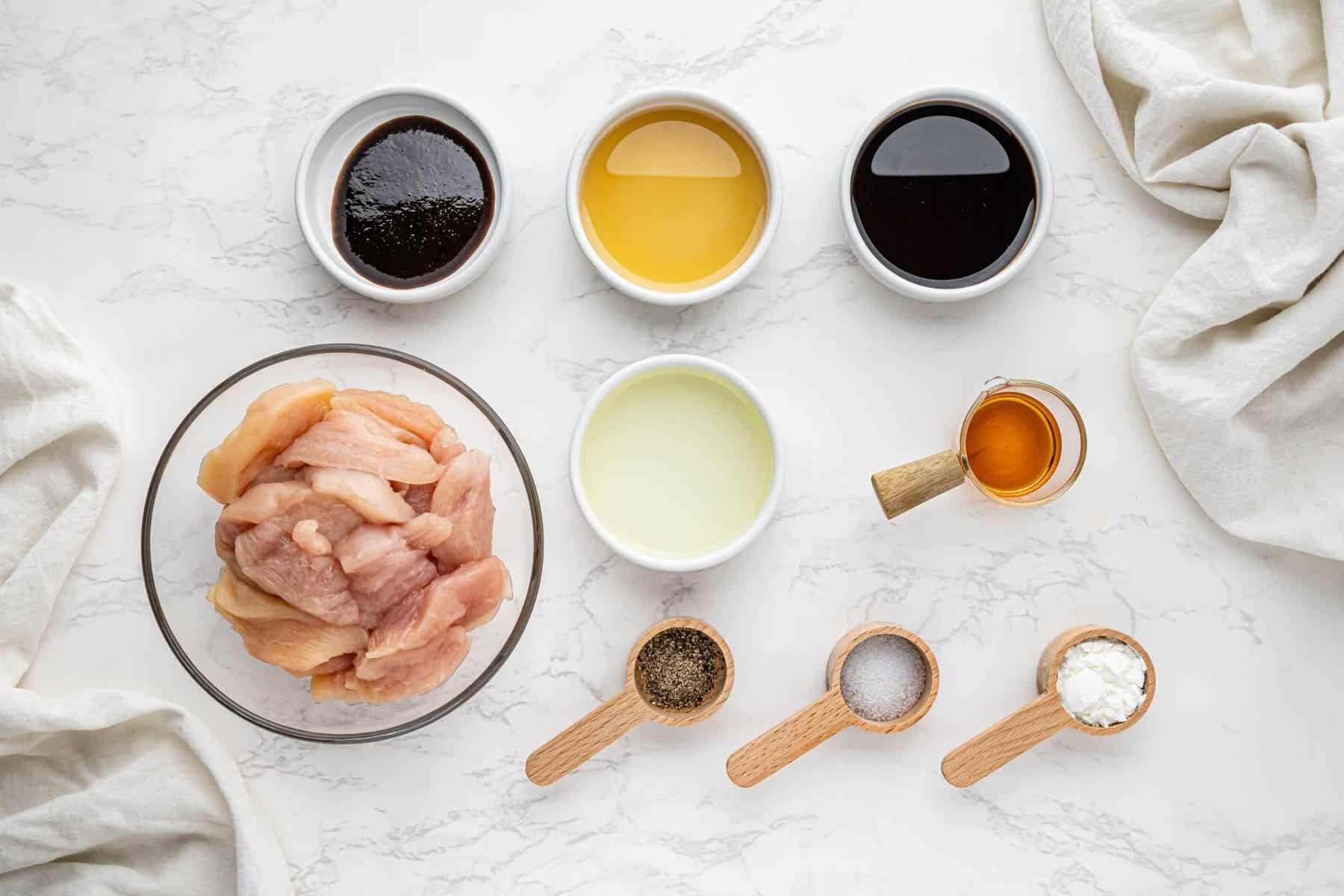 overhead view of chicken marinade ingredients in bowls and spoons