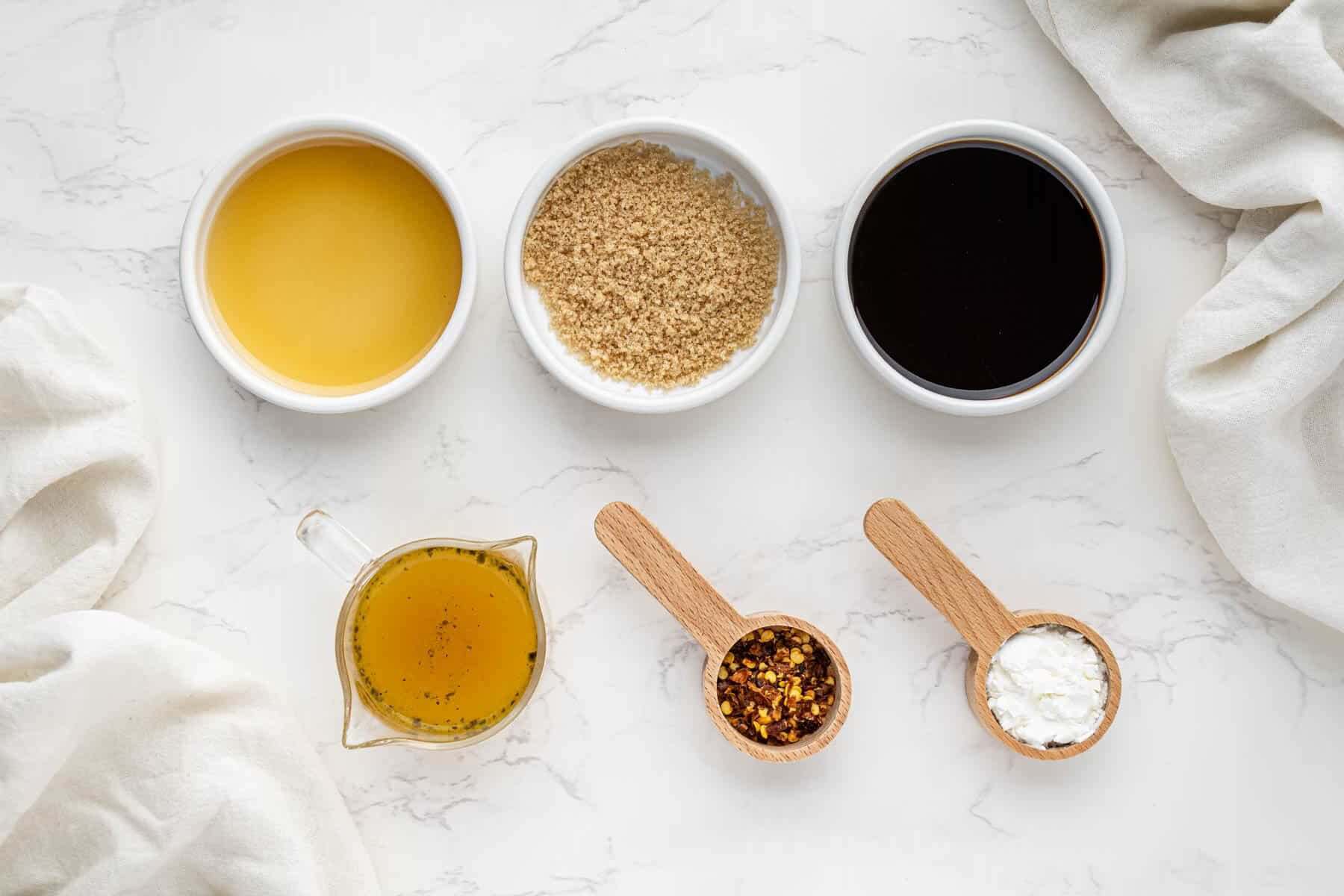 overhead view of sauce ingredients in bowls and spoons
